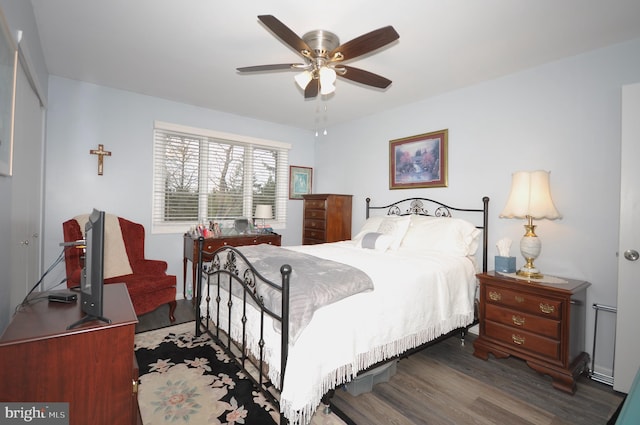 bedroom featuring ceiling fan and dark wood-type flooring