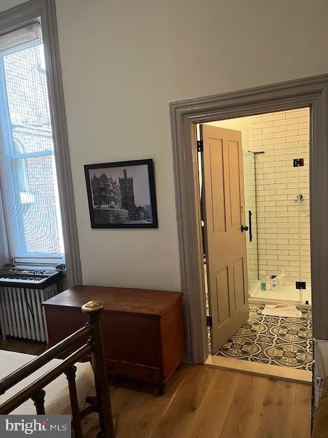 2112 Pine St Unit 1, Philadelphia, PA 19103 - foyer entrance with wood finished floors and radiator