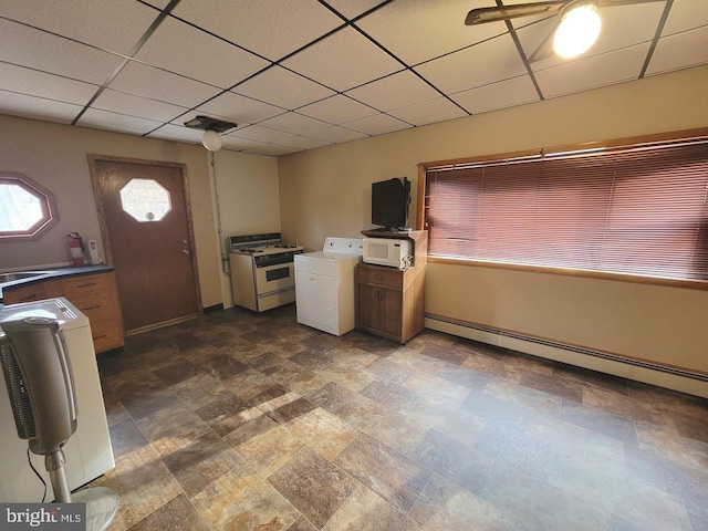 kitchen featuring gas stove, a paneled ceiling, baseboard heating, and washer / dryer