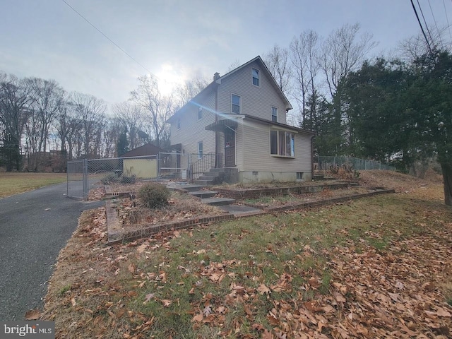 view of side of property with a lawn