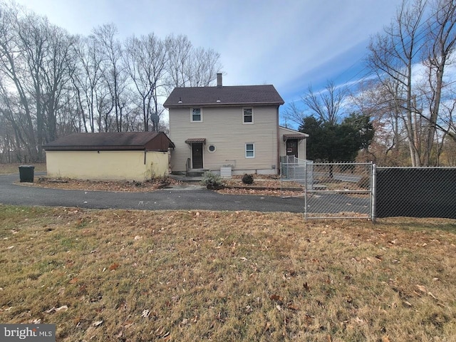 rear view of house featuring a yard