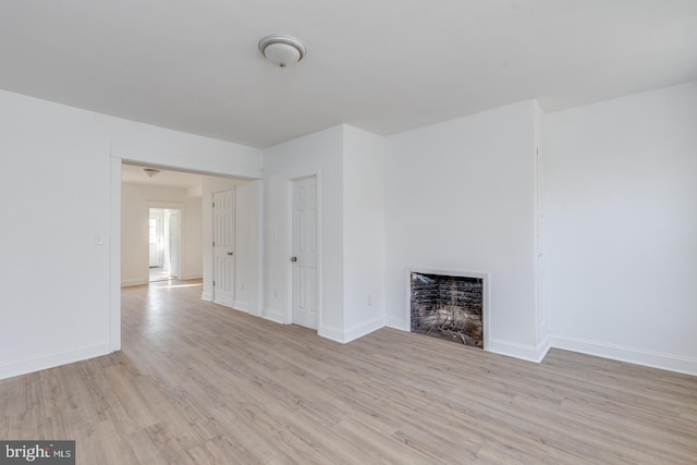 unfurnished living room with light hardwood / wood-style flooring