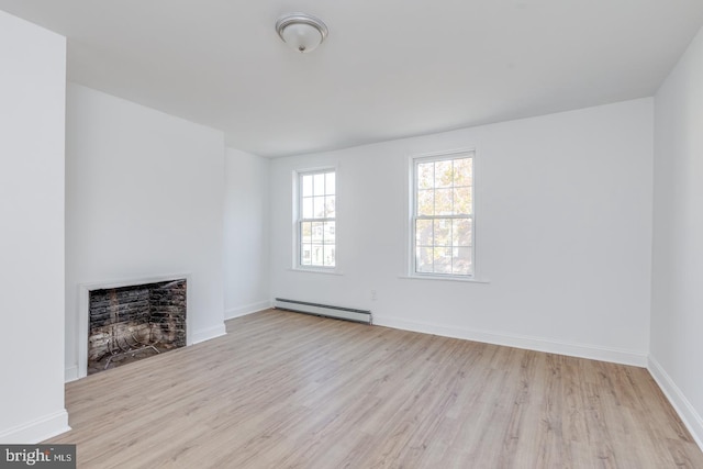 unfurnished living room with light hardwood / wood-style floors and baseboard heating