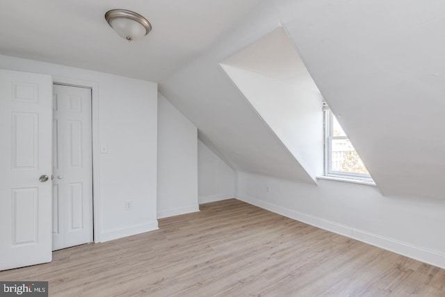 bonus room featuring light hardwood / wood-style floors and lofted ceiling