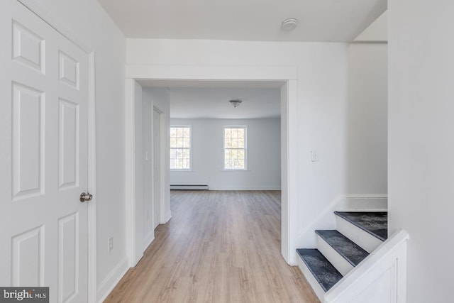 hallway featuring baseboard heating and light wood-type flooring