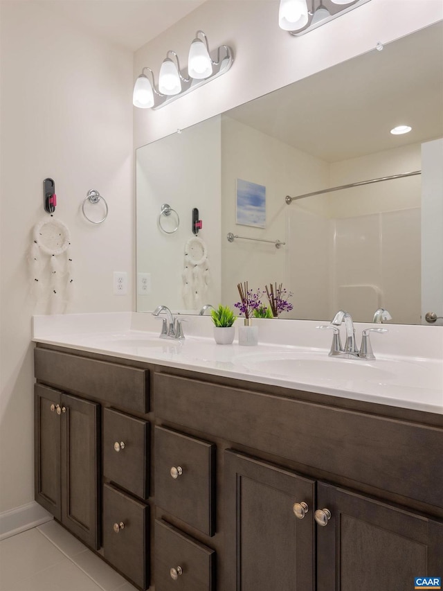 bathroom featuring tile patterned floors, a shower, and vanity