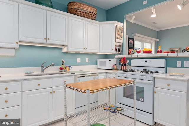 kitchen featuring white cabinetry, sink, white appliances, light tile patterned floors, and ornamental molding