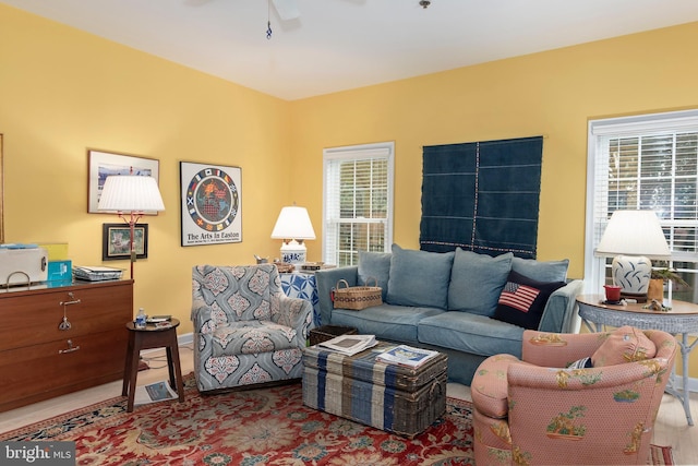 living room with ceiling fan and light hardwood / wood-style flooring