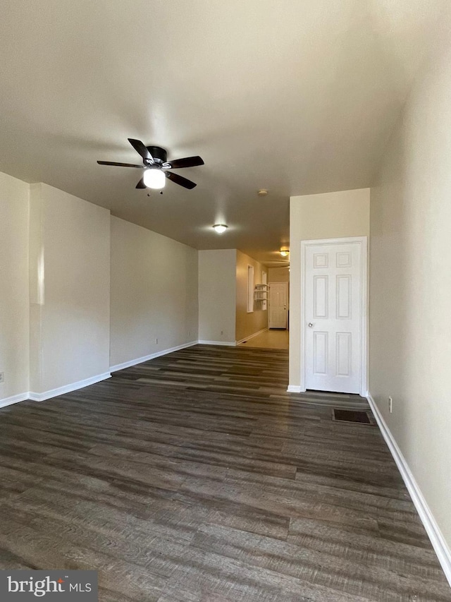 spare room with ceiling fan and dark hardwood / wood-style flooring