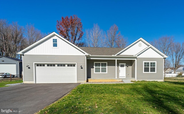 view of front of home featuring a front yard and a garage