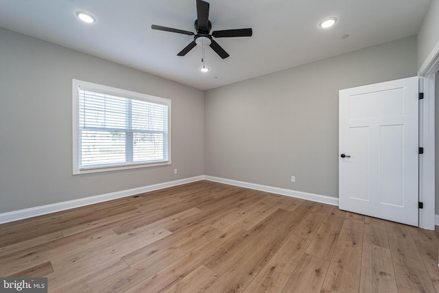 unfurnished room with ceiling fan and light hardwood / wood-style floors