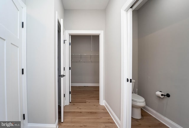 bathroom featuring wood-type flooring and toilet