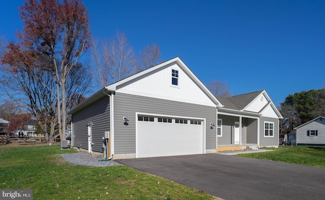 view of front of property with a garage, a front yard, and central AC