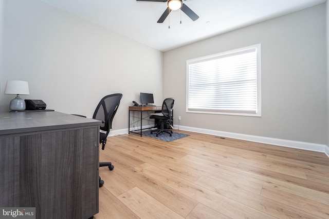 office area with light hardwood / wood-style flooring and ceiling fan