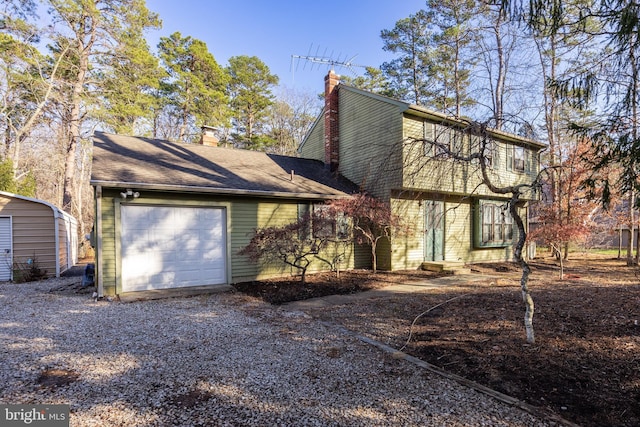 rear view of house featuring a garage