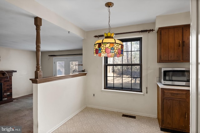 unfurnished dining area with light colored carpet