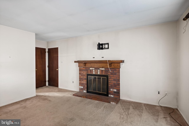 unfurnished living room featuring a fireplace and carpet floors