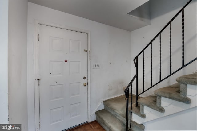 foyer entrance with dark parquet floors