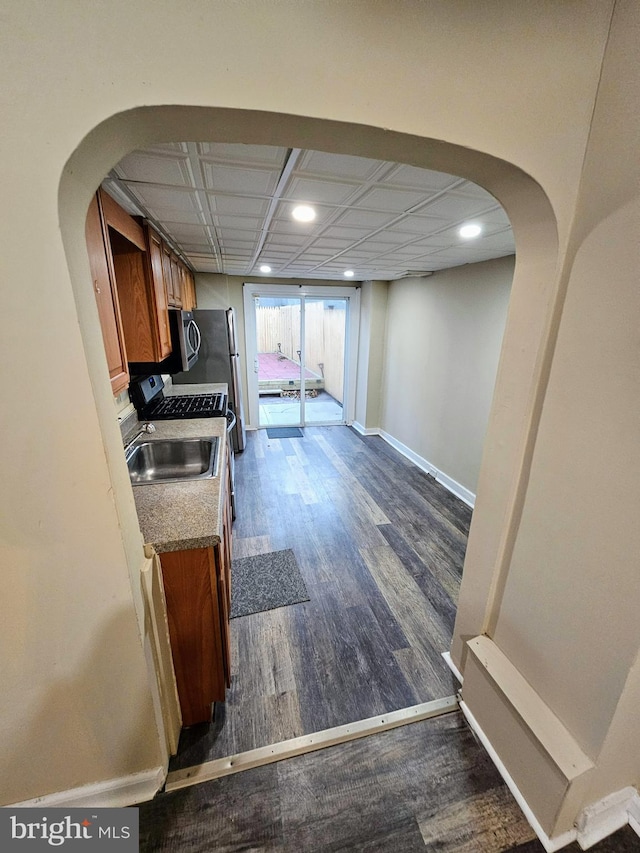 kitchen with stainless steel electric range oven, dark hardwood / wood-style flooring, and sink