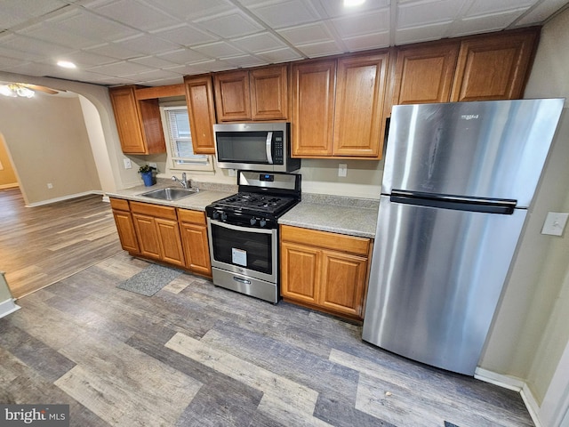 kitchen featuring stainless steel appliances, hardwood / wood-style flooring, and sink