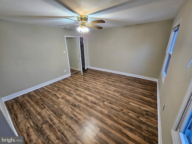 unfurnished room with ceiling fan and dark hardwood / wood-style flooring