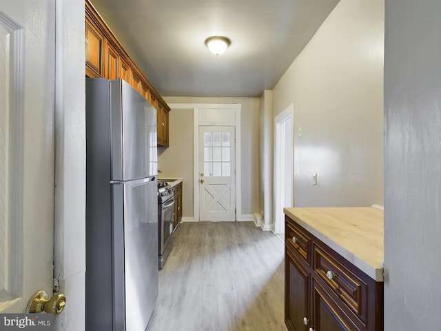 kitchen featuring light wood-type flooring and stainless steel appliances