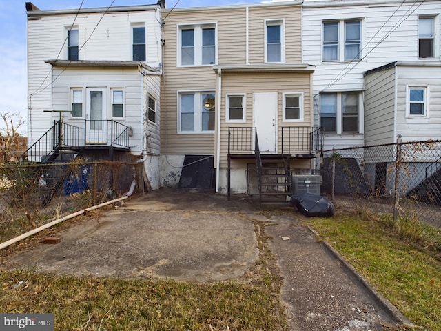 rear view of property featuring central air condition unit