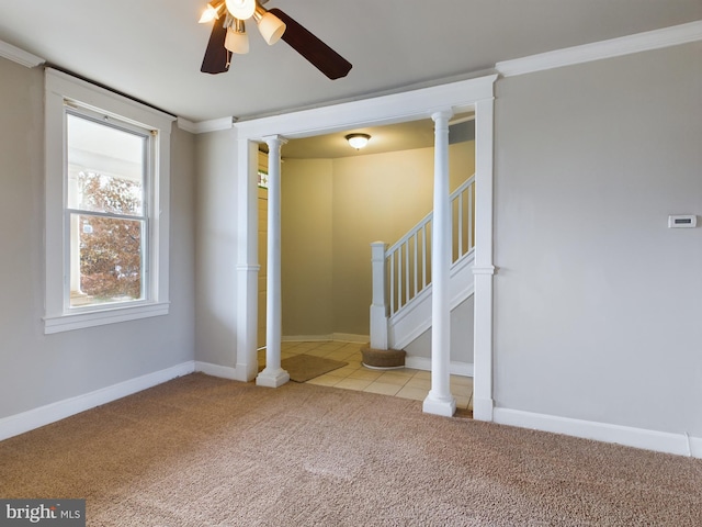 carpeted spare room with ceiling fan and ornamental molding