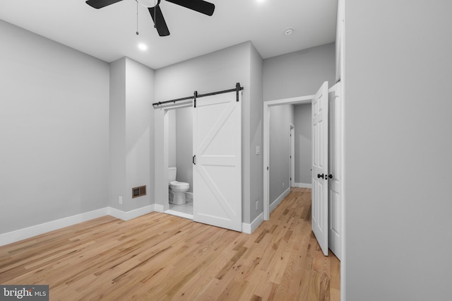 bathroom featuring hardwood / wood-style flooring, ceiling fan, and toilet