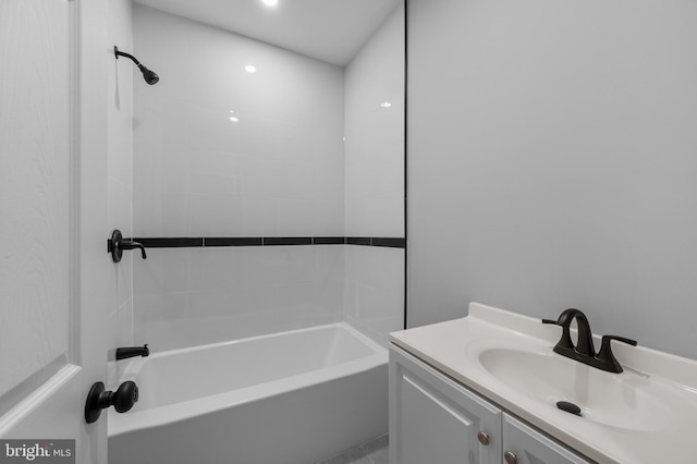 bathroom with vanity and tiled shower / bath combo