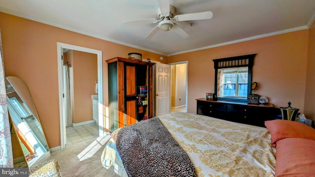 bedroom featuring light carpet, ensuite bath, ceiling fan, and crown molding