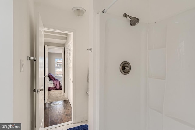 bathroom featuring walk in shower and hardwood / wood-style flooring