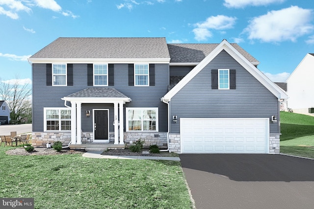 view of front of home featuring a garage and a front lawn