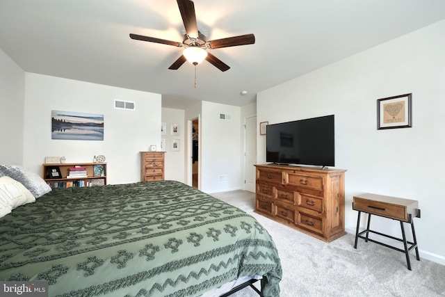 bedroom featuring carpet floors, a closet, a spacious closet, and ceiling fan