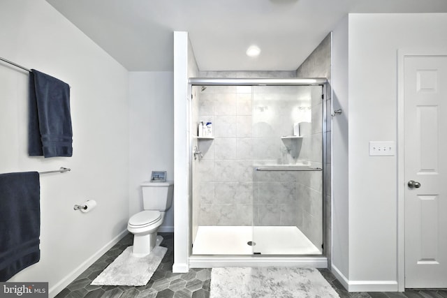 bathroom featuring an enclosed shower and toilet