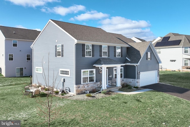 view of front facade featuring a front lawn and a garage