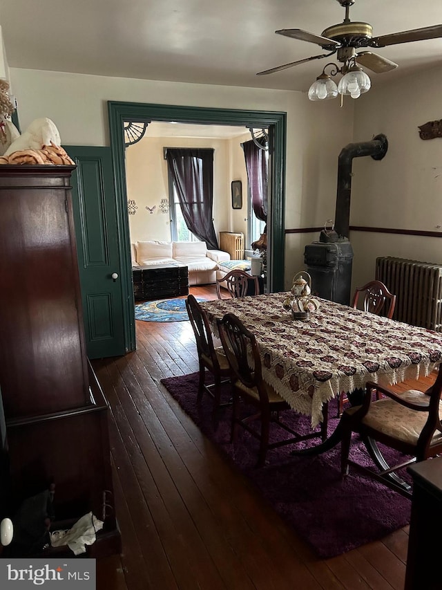 dining room with dark hardwood / wood-style flooring, radiator, and ceiling fan