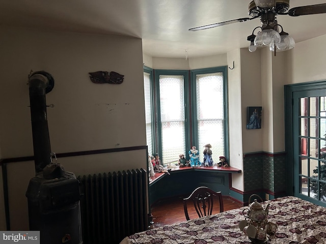 dining area with radiator heating unit, ceiling fan, and a healthy amount of sunlight