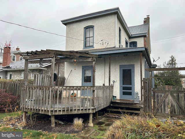 back of house featuring a wooden deck