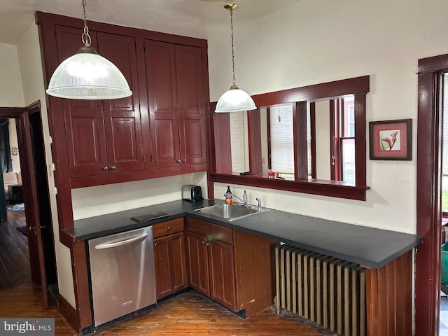 kitchen featuring pendant lighting, dishwasher, dark wood-type flooring, radiator, and sink