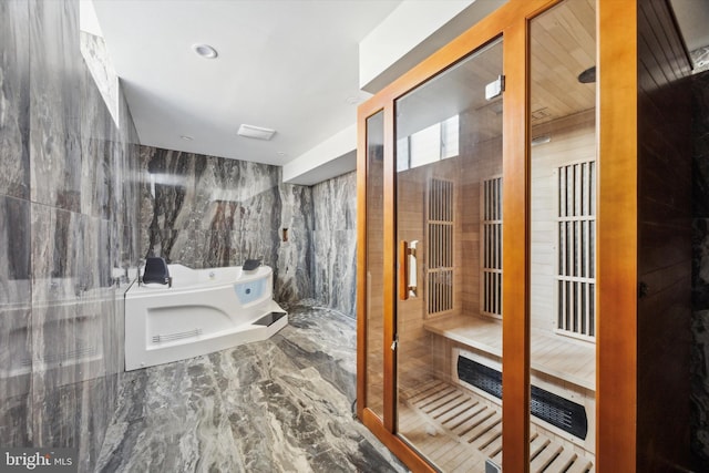 bathroom with tile walls and plus walk in shower