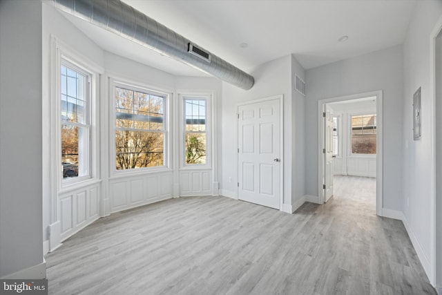 interior space with light hardwood / wood-style flooring and plenty of natural light