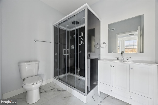 bathroom featuring vanity, an enclosed shower, and toilet