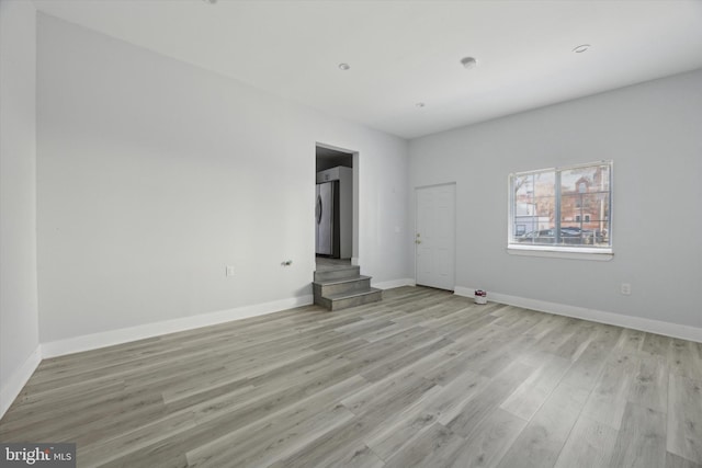 spare room featuring light hardwood / wood-style flooring