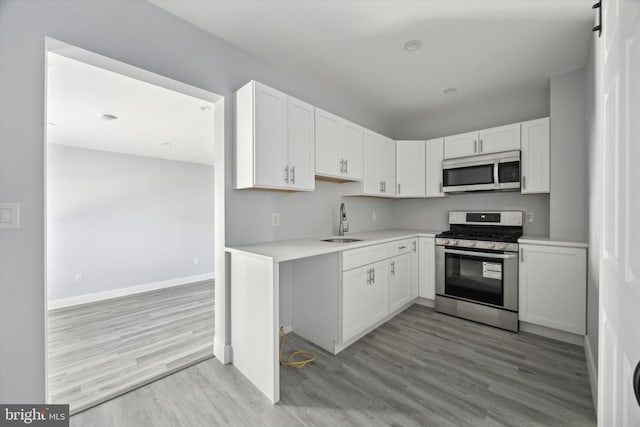 kitchen with white cabinetry, sink, and appliances with stainless steel finishes