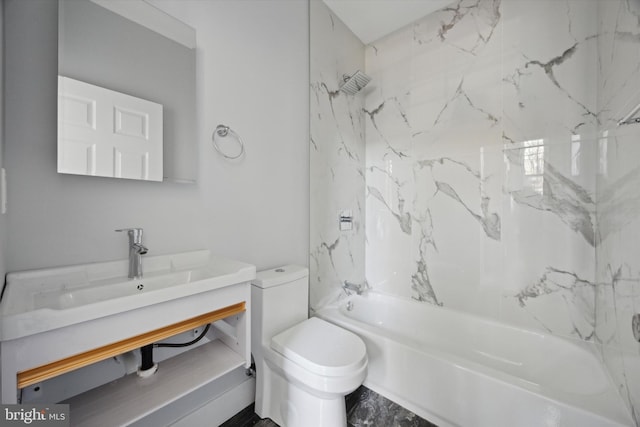 full bathroom featuring toilet, vanity, and tiled shower / bath