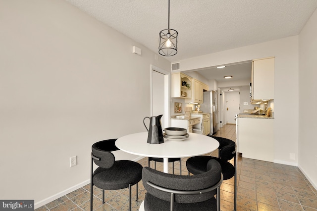 dining area featuring a textured ceiling