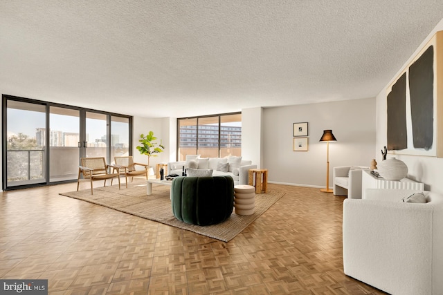 living room with a textured ceiling, parquet floors, and expansive windows