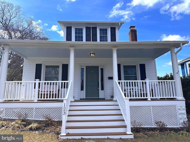 bungalow-style house with a chimney and a porch