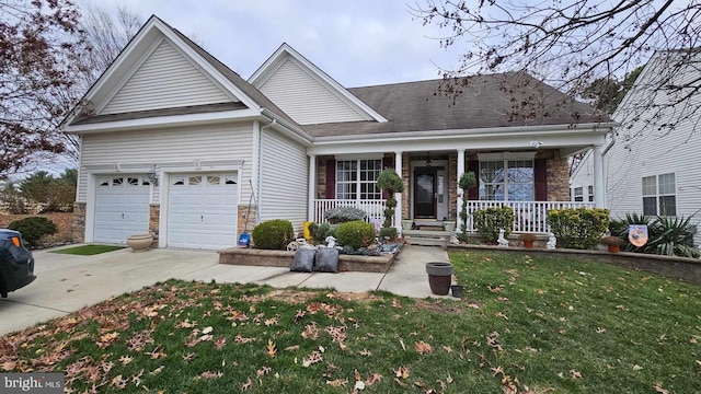 view of front of house featuring covered porch, a garage, and a front yard